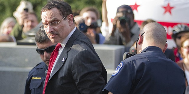 April 11: Mayor Vincent Gray is searched by Capitol Hill police after being arrested in Washington.