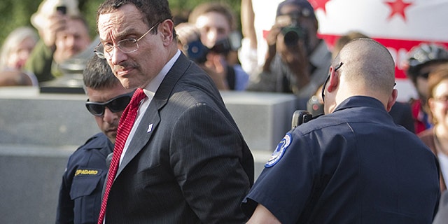 April 11: Mayor Vincent Gray is searched by Capitol Hill police after being arrested in Washington.