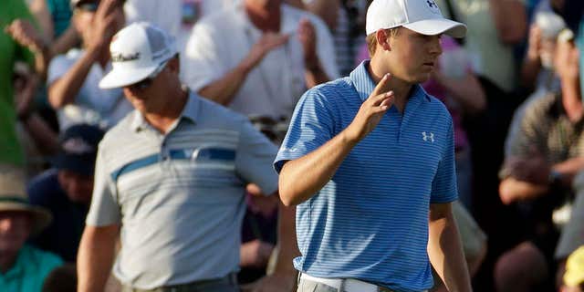 April 11, 2015: Jordan Spieth waves after putting out on the 18th hole during the third round of the Masters golf tournament .