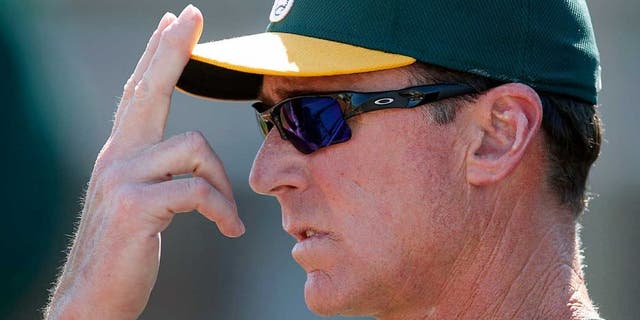 Mar 23, 2015; Goodyear, AZ, USA; Oakland Athletics manager Bob Melvin (6) gives out signs in the first inning against the Cleveland Indians during a spring training game at Goodyear Ballpark. Mandatory Credit: Rick Scuteri-USA TODAY Sports