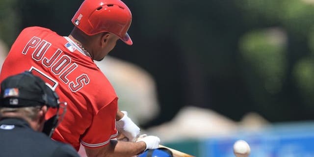 Apr 12, 2015; Anaheim, CA, USA; Los Angeles Angels first baseman Albert Pujols (5) connects for a solo home run in the first inning of the game against the Kansas City Royals at Angel Stadium of Anaheim. Mandatory Credit: Jayne Kamin-Oncea-USA TODAY Sports
