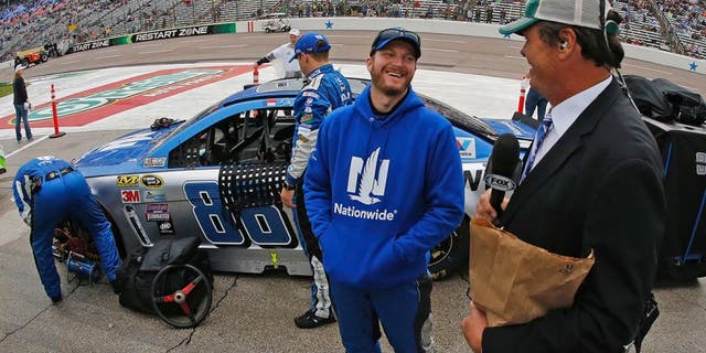 Sprint Cup Series driver Dale Earnhardt Jr. (88) with broadcaster Michael Waltrip on a rain-soaked pit row before the Duck Commander 500 on Saturday, April 9, 2016, at Texas Motor Speedway in Fort Worth, Texas. (Paul Moseley/Fort Worth Star-Telegram/TNS via Getty Images)