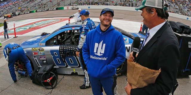 Sprint Cup Series driver Dale Earnhardt Jr. (88) with broadcaster Michael Waltrip on a rain-soaked pit row before the Duck Commander 500 on Saturday, April 9, 2016, at Texas Motor Speedway in Fort Worth, Texas. (Paul Moseley/Fort Worth Star-Telegram/TNS via Getty Images)