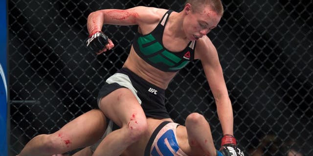LAS VEGAS, NEVADA - DECEMBER 10: (Top) Rose Namajunas punches Paige VanZant in their women's strawweight bout during the UFC Fight Night event at The Chelsea at the Cosmopolitan of Las Vegas on December 10, 2015 in Las Vegas, Nevada. (Photo by Brandon Magnus/Zuffa LLC/Zuffa LLC via Getty Images)