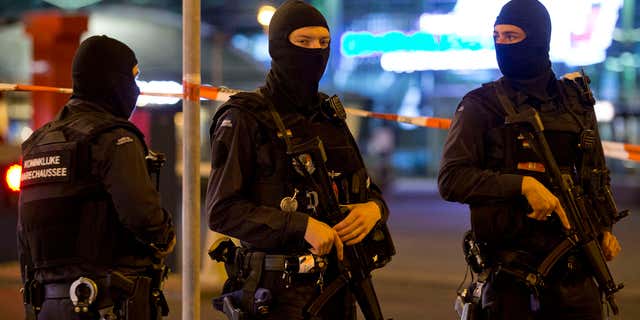 April 13, 2016: Hooded military police officers guard a part of Schiphol Aiport in Amsterdam, Netherlands.