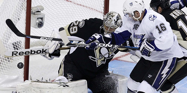 April 13: Pittsburgh Penguins goalie Marc-Andre Fleury (29) blocks a shot by Tampa Bay Lightning's Teddy Purcell (16) in the first period of Game 1 of a first-round NHL hockey playoff series in Pittsburgh.
