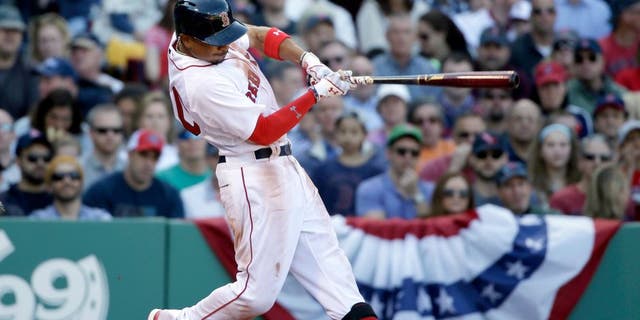 Boston Red Sox's Mookie Betts hits a three-run home run off a pitch by Washington Nationals' Jordan Zimmermann in the second inning of a baseball game, Monday, April 13, 2015, in Boston. (AP Photo/Steven Senne)