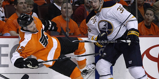 April 14: Philadelphia Flyers' Ville Leino, left, of Finland, is knocked down by Buffalo Sabres' Patrick Kaleta in the first period of Game 1 of a first-round NHL hockey playoff series in Philadelphia.