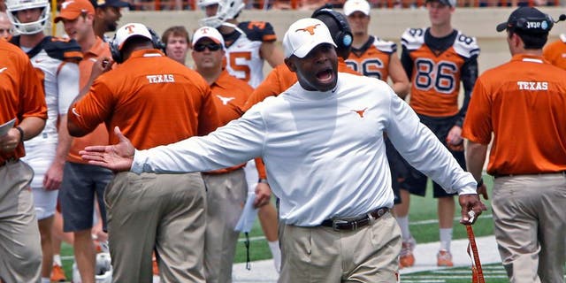 Texas coach Charlie Strong calls out to his players during the first half of the team's Orange and White spring NCAA college football game, Saturday, April 19, 2014, in Austin, Texas. (AP Photo/Michael Thomas)