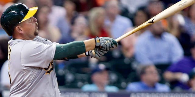 Apr 13, 2015; Houston, TX, USA; Oakland Athletics designated hitter Billy Butler (16) hits a home run during the fifth inning against the Houston Astros at Minute Maid Park. Mandatory Credit: Troy Taormina-USA TODAY Sports