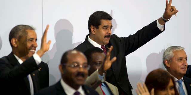 April 11, 2015: Venezuela's President Nicolas Maduro, center top, flashes a sign during the VII Summit of the Americas' official group photo in Panama City, Panama.