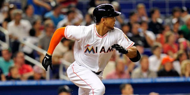 Apr 15, 2014; Miami, FL, USA; Miami Marlins right fielder Giancarlo Stanton connects for an RBI single during the fifth inning against the Washington Nationals at Marlins Ballpark. Mandatory Credit: Steve Mitchell-USA TODAY Sports