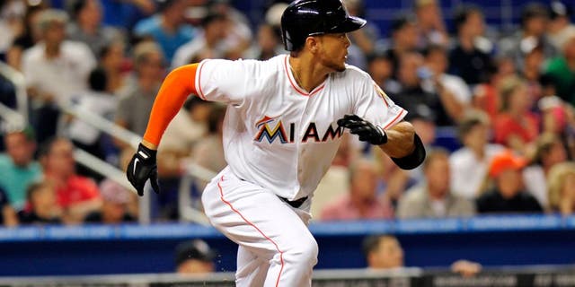 Apr 15, 2014; Miami, FL, USA; Miami Marlins right fielder Giancarlo Stanton connects for an RBI single during the fifth inning against the Washington Nationals at Marlins Ballpark. Mandatory Credit: Steve Mitchell-USA TODAY Sports