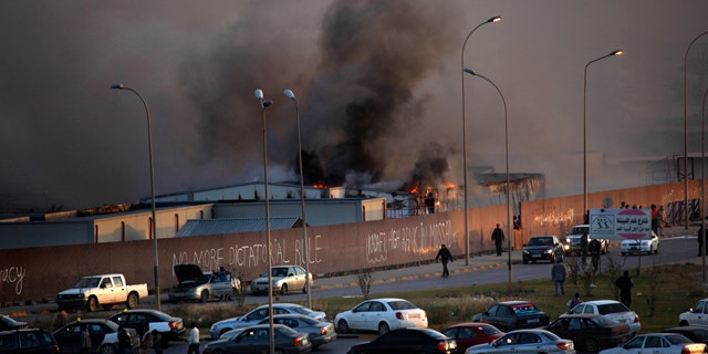April 15: Fire and smoke rises from storage warehouse at a construction site that is run by a foreign company, with no clear causes of the incident, in Benghazi, Libya.