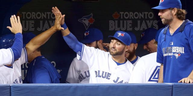 TORONTO, CANADA - APRIL 15: Kevin Pillar #11 of the Toronto Blue Jays is congratulated by teammates after making a leaping catch in the seventh inning during an MLB game against the Tampa Bay Rays on April 15, 2015 at Rogers Centre in Toronto, Ontario, Canada. All uniformed team members are wearing jersey number 42 in honor of Jackie Robinson Day. (Photo by Tom Szczerbowski/Getty Images)