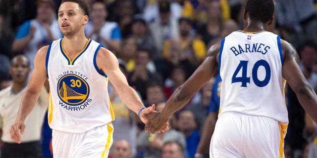 April 9, 2015; Oakland, CA, USA; Golden State Warriors guard Stephen Curry (30) celebrates with forward Harrison Barnes (40) against the Portland Trail Blazers during the first quarter at Oracle Arena. Mandatory Credit: Kyle Terada-USA TODAY Sports