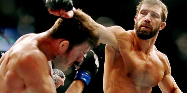 SYDNEY, AUSTRALIA - NOVEMBER 08: Michael Bisping of England ducks a punch from Luke Rockhold of the USA in their middleweight fight during the UFC Fight Night 55 event at Allphones Arena on November 8, 2014 in Sydney, Australia. (Photo by Mark Kolbe/Getty Images)