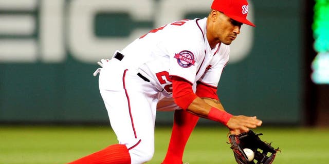 Apr 16, 2015; Washington, DC, USA; Washington Nationals shortstop Ian Desmond (20) fields a ground ball during the game against the Philadelphia Phillies at Nationals Park. The Nationals won 5-2. Mandatory Credit: Evan Habeeb-USA TODAY Sports