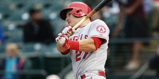 Apr 14, 2015; Arlington, TX, USA; Los Angeles Angels center fielder Mike Trout (27) follows through on a double against the Texas Rangers during the first inning of a baseball game at Globe Life Park in Arlington. Mandatory Credit: Jim Cowsert-USA TODAY Sports