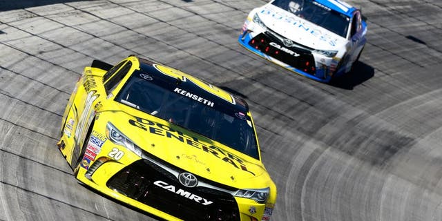 BRISTOL, TN - APRIL 17: Matt Kenseth, driver of the #20 Dollar General Toyota, leads Carl Edwards, driver of the #19 Comcast Business Toyota, during the NASCAR Sprint Cup Series Food City 500 at Bristol Motor Speedway on April 17, 2016 in Bristol, Tennessee. (Photo by Matt Sullivan/Getty Images)