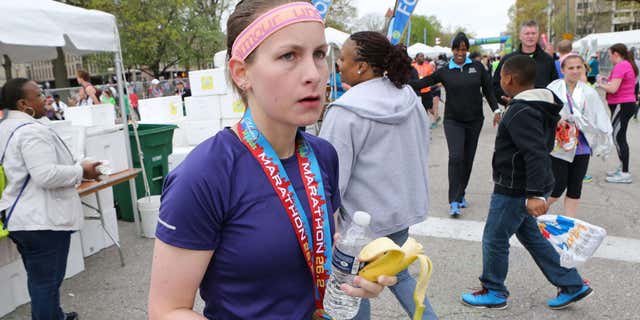 April 12, 2015: Kendall Schler, 26, is seen moments after crossing the finish line of the Go! Marathon.
