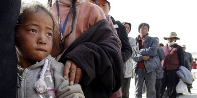 A Tibetan child stands in a line waiting for medical treatment at a temporary hospital set up for quake victims in earthquake-hit Yushu county in west China's Qinghai province (AP).