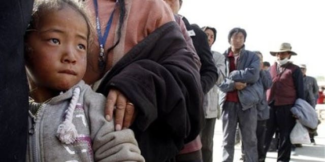 A Tibetan child stands in a line waiting for medical treatment at a temporary hospital set up for quake victims in earthquake-hit Yushu county in west China's Qinghai province (AP).