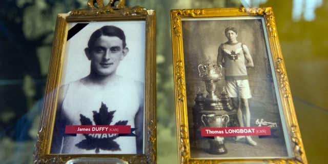 June 14, 2014: In this photo illustrations of World War I soldiers and Boston Marathon winners James Duffy, 1914, and Tom Longboat, 1907, are framed behind glass on exhibit at the In Flanders Fields Museum in Ypres, Belgium.