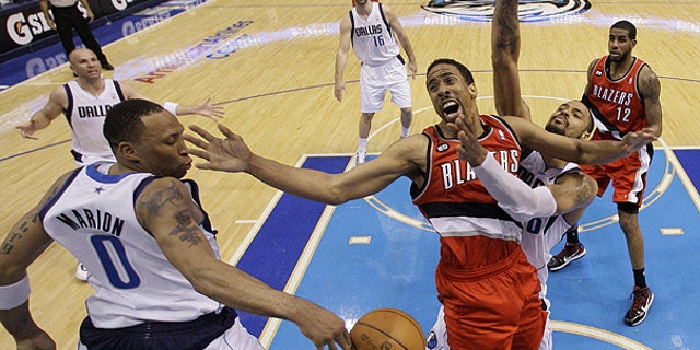 April 19: Portland Trail Blazers' Andre Miller, center, loses control of the ball going to the basket against Dallas Mavericks' Shawn Marion (0) and Tyson Chandler, right, in the second half of an NBA basketball game in Dallas.