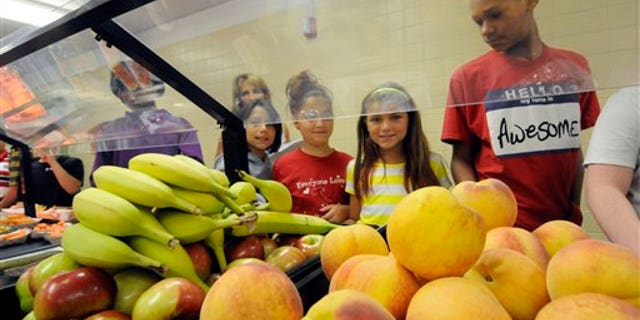 Students select food items from the lunch line of the cafeteria at Draper Middle School in Rotterdam, N.Y., Tuesday, Sept. 11, 2012. The leaner, greener school lunches served under new federal standards are getting mixed grades from students. (AP Photo/Hans Pennink)