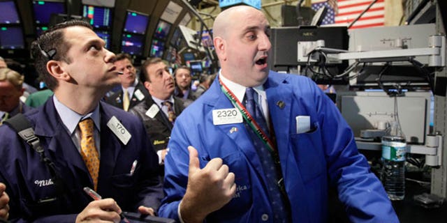 April 19: A specialist directs trades in shares of Goldman Sachs on the floor of the New York Stock Exchange.