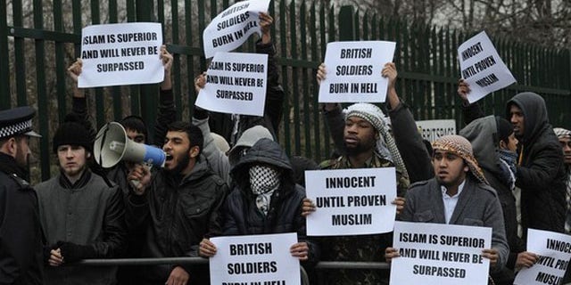 Feb. 23: Demonstrators supporting Mohammad Haque and Emdadur Choudhury protest as they arrive at Belmarsh Magistrates Court in south-east London. The trial of two men accused of burning poppies on the anniversary of Armistice Day started on Wednesday. Mohammad Haque, 30, and Emdadur Choudhury, 26, were arrested during a demonstration by Islamist group Muslims Against Crusades in Kensington, west London, on November 11.