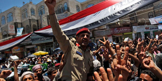 April 20: A Yemeni army officer lifted by anti-government protestors reacts during a demonstration demanding the resignation of Yemeni President Ali Abdullah Saleh in Sanaa, Yemen.