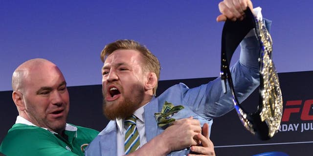 DUBLIN, IRELAND - MARCH 31: UFC featherweight title challenger Conor 'The Notorious' McGregor (R) steals UFC Featherweight Champion Jose Aldo's (L) belt as UFC President Dana White (C) separates the two during the UFC 189 World Championship Fan Event on March 31, 2015 in Dublin, Ireland. (Photo by Jeff Bottari/Zuffa LLC/Zuffa LLC via Getty Images)