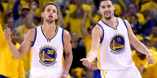 OAKLAND, CA - APRIL 20: Stephen Curry #30, and Klay Thompson #11 of the Golden State Warriors reacts after Curry hit a jump shot against the New Orleans Pelicans in the fourth quarter during the first round of the 2015 NBA Playoffs at ORACLE Arena on April 20, 2015 in Oakland, California. NOTE TO USER: User expressly acknowledges and agrees that, by downloading and or using this photograph, User is consenting to the terms and conditions of the Getty Images License Agreement. (Photo by Thearon W. Henderson/Getty Images)
