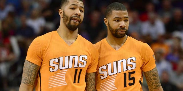 Mar 27, 2015; Phoenix, AZ, USA; Phoenix Suns forward Markieff Morris (11) and Phoenix Suns forward Marcus Morris (15) talk during a timeout against the Portland Trail Blazers at US Airways Center. The Trail Blazers won the game 87-81. Mandatory Credit: Joe Camporeale-USA TODAY Sports