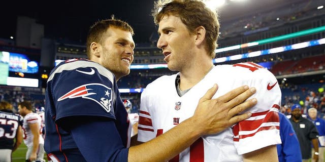 FOXBORO, MA - AUGUST 29: Tom Brady #12 of the New England Patriots talks to Eli Manning #10 of the New York Giants following their preseason game at Gillette Stadium on August 29, 2013 in Foxboro, Massachusetts. (Photo by Jared Wickerham/Getty Images)
