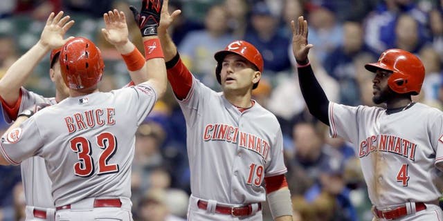 MILWAUKEE, WI - APRIL 21: Jay Bruce #32 of the Cincinnati Reds celebrates with Todd Frazier #21, Joey Votto #19 and Brandon Phillips #4 after hitting a grand slam in the third inning against the Milwaukee Brewers at Miller Park on April 21, 2015 in Milwaukee, Wisconsin. (Photo by Mike McGinnis/Getty Images)