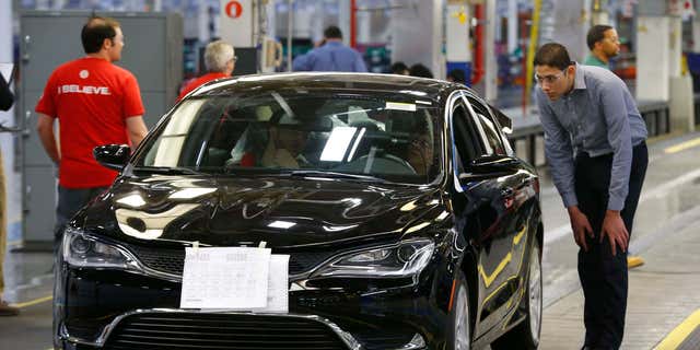 FILE - In this March 14, 2014 file photo, a 2015 Chrysler 200 automobile rolls down the assembly line at the Sterling Heights Assembly Plant in Sterling Heights, Mich.