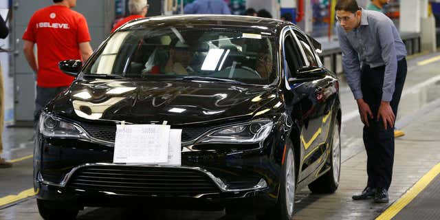 FILE - In this March 14, 2014 file photo, a 2015 Chrysler 200 automobile rolls down the assembly line at the Sterling Heights Assembly Plant in Sterling Heights, Mich.