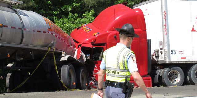April 22, 2015: A Georgia state trooper works the scene of a deadly crash in which five people died and three others were injured.