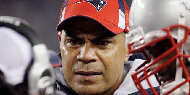 Nov. 22, 2009: New England Patriots linebacker Junior Seau, center, talks to teammates on the sidelined during an NFL football game against the New York Jets in Foxborough, Mass.