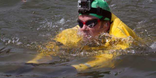 April 22, 2015: Clean-water advocate Christopher Swain swims in the Gowanus Canal in the Brooklyn borough of New York.