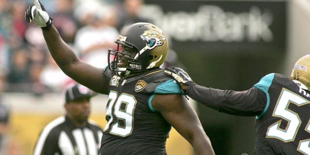 Dec 7, 2014; Jacksonville, FL, USA; Jacksonville Jaguars defensive tackle Sen'Derrick Marks (99) celebrates after a sack in the first quarter of their game against the Houston Texans at EverBank Field. Mandatory Credit: Phil Sears-USA TODAY Sports