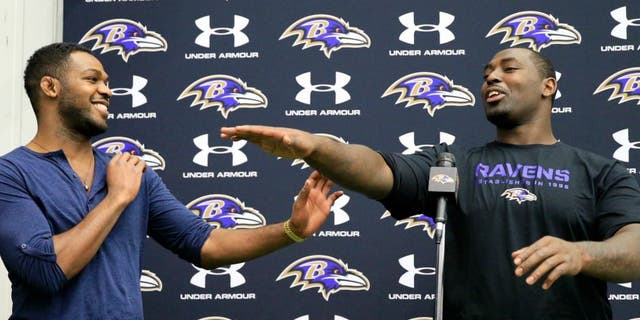 on November 13, 2013 in Owings Mills, Maryland.,OWINGS MILLS, MD - NOVEMBER 13: UFC fighter Jon Jones (L) jokes around with his brother defensive end Arthur Jones #97 of the Baltimore Ravens during a news conference at the teams training facility November 13, 2013 in Owings Mills, Maryland. (Photo by Rob Carr/Getty Images)