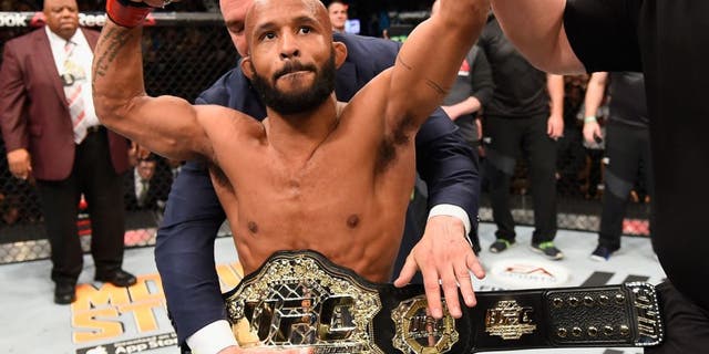 LAS VEGAS, NV - APRIL 23: Demetrious Johnson celebrates his TKO victory over Henry Cejudo in their flyweight championship bout during the UFC 197 event inside MGM Grand Garden Arena on April 23, 2016 in Las Vegas, Nevada. (Photo by Josh Hedges/Zuffa LLC/Zuffa LLC via Getty Images)