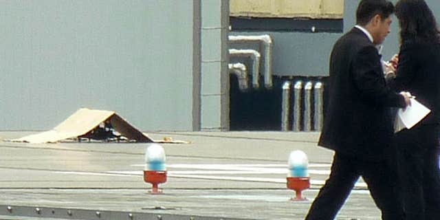 April 22, 2015: A small drone covered with cardboard, is seen on the roof of Prime Minister Shinzo Abe's official residence in Tokyo.