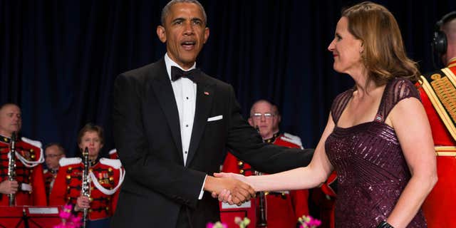 April 25, 2015: President Barack Obama, left, is greeted by White House Correspondents Association president Christi Parsons during the White House Correspondents' Association dinner at the Washington Hilton