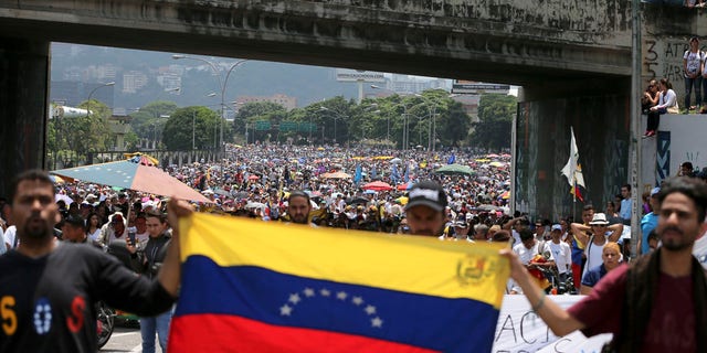 Anti-government protesters block a highway in Caracas, Venezuela, Monday, April 24, 2017.