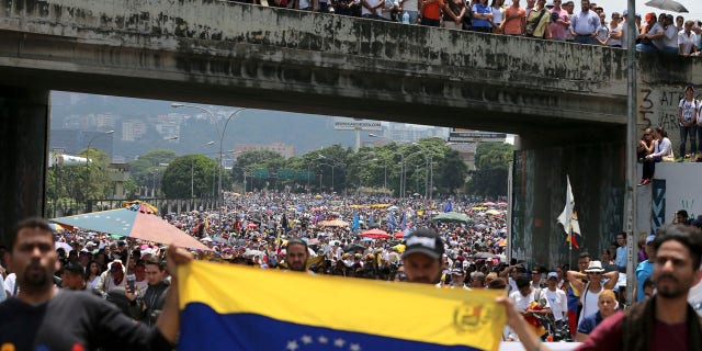 Anti-government protesters block a highway in Caracas, Venezuela, Monday, April 24, 2017.